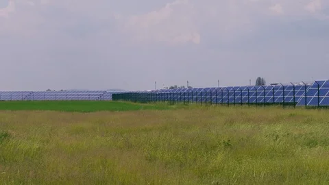 Solar park with solar cell panels against green grass field Stock Footage 108673088