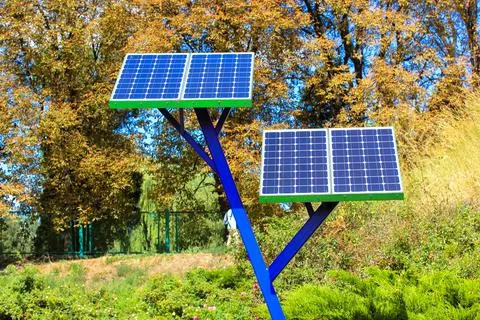 Solar power array panels installed in park for charging phones.Battery generator Fotos de archivo