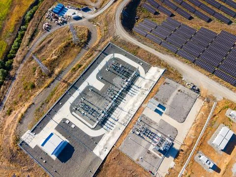 Solar power facility with electrical substation in a rural area in day time Stock Photos