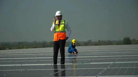 Solar power plant engineer manager talking by walkie talkie control inspectin Stock Footage 154286875
