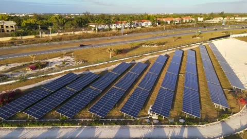 Solar power plant rows at sunset near the highway. Farm producing clean Stock-Footage 273175606