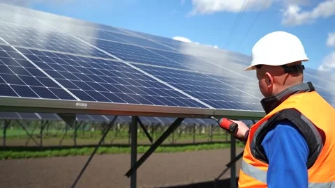 Solar power plant worker checks battery bolts for tightness. Stock Footage 168178468
