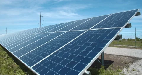 Solar power station with long rows of solar panels on a sunny day, 4k Stock Footage 134003564