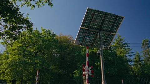 Solar-Powered CCTV System on Pole Monitoring Rail Crossing Stock Footage 345286255