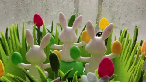 Solar powered Easter bunnies in Window frame Stock Footage 148161347