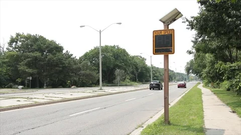 Solar powered electronic yellow and black your speed sign on wood post Stock Footage 247748830