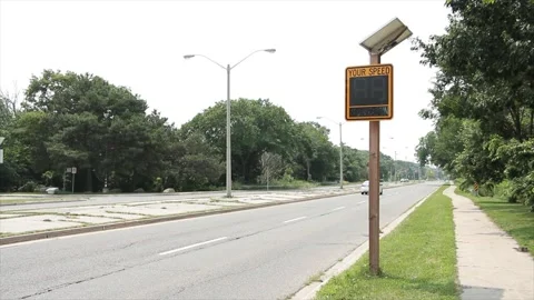 Solar powered electronic yellow and black your speed sign on wood post Stock Footage 247748847
