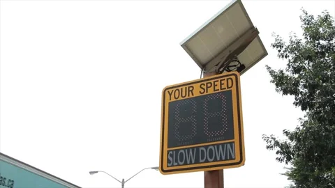 Solar powered electronic yellow and black your speed sign on wood post Stock Footage 247748857