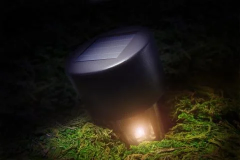 Solar powered flashlight on the background of nature. Stock Photos
