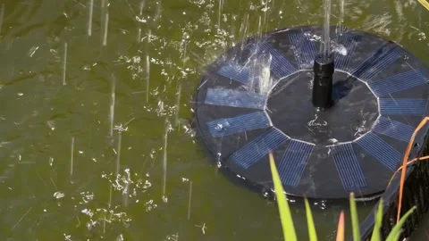 Solar Powered Fountain Circulating Water in Outdoor Pond on Sunny Day 스톡 동영상 336720342