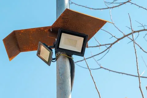 Solar powered led spotlight mounted on the outer wall of the warehouse Stock Photos