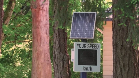 Solar powered radar speed sign 35 kmh in forest road Stock Footage 341799894