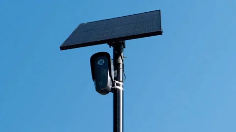 Solar Powered Surveillance Camera on Pole Against Blue Sky Stock Footage 344337242