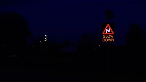 Solar powered traffic triggered slow down roadsign before sharp bends uk Stock Footage 88396175