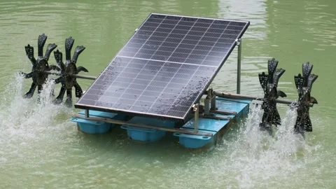 Solar-powered water aerator system with rotating paddles in a pond for Stock Footage 284962060