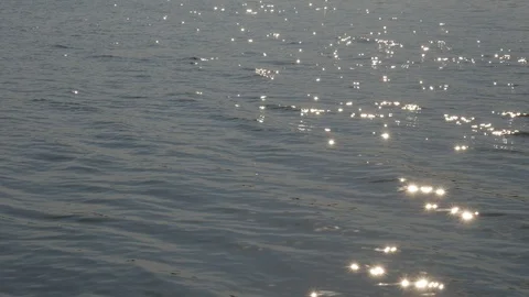 Solar reflections and glare on the surface of soothing waves of water in summer Stock Footage 117522781
