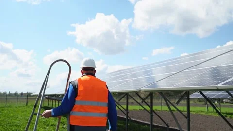 Solar Station Worker Carrying Stepladder. Solar Panel Farm Maintenance Stock Footage 168178370