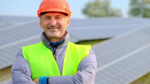Solar substation behind happy engineer smiling near panels 스톡 동영상 165726717