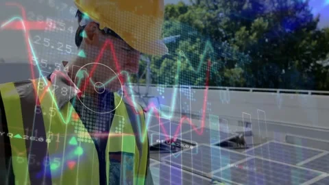 Solar tech typing on laptop starting finance graphs on rooftop panels, donning Stock Footage 334034583