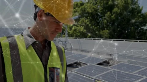 Solar technician typing on laptop and activating overlay across array while Stock-Footage 333830386