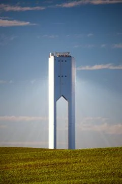 Solar tower with rays  - thermo-solar power - blue sky and green grass Stock Photos
