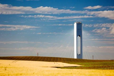 Solar tower with rays  - thermo-solar power - blue sky and yellow field Stock Photos