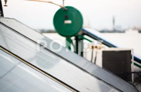 Solar water heater panels with a green water tank out of focus Stock Photos