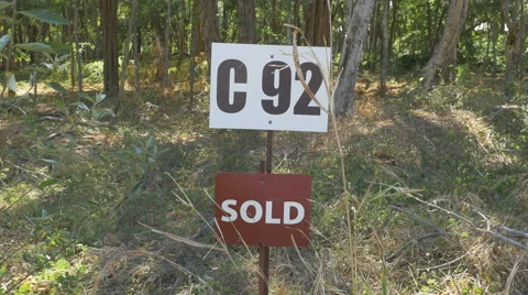 Sold sign in front of plot of land. Closeup. Costa Rica. Stock Footage 49392593