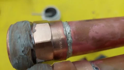 Soldered copper pipe joints with threaded brass fittings and thread sealant past Stock Footage 336561700