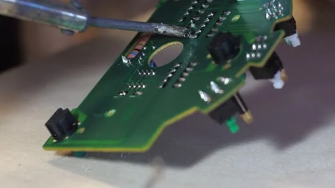Soldering the board with solder. repair of the control unit board Stock Footage 166314315