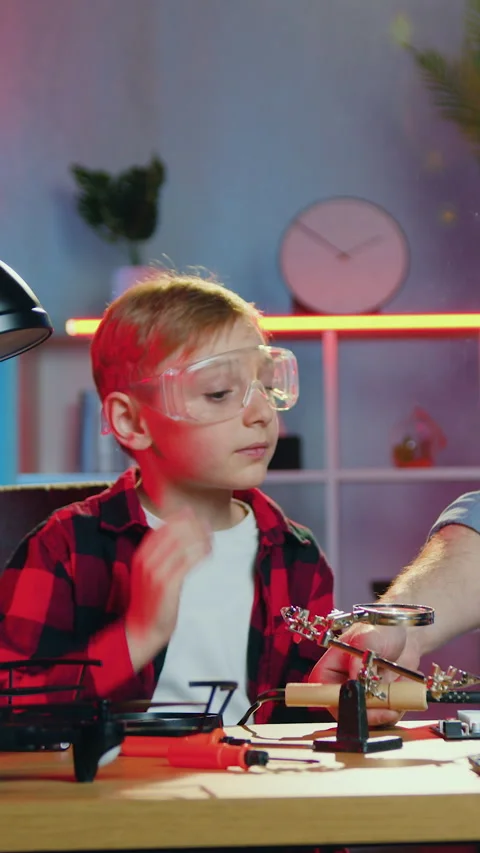 Soldering concept where handsome skilled bearded dad in special protective glass Stock Footage 329708139