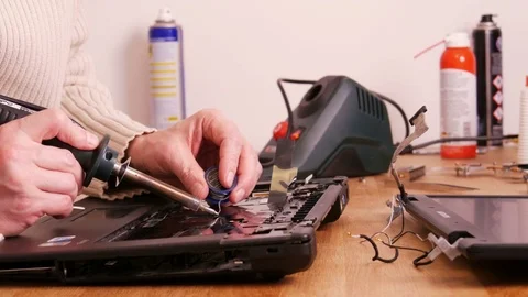 Soldering contacts on laptop computer - 4K Stock Footage 76940800