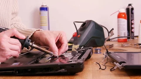 Soldering contacts on laptop computer - 4K Stock Footage 76941335