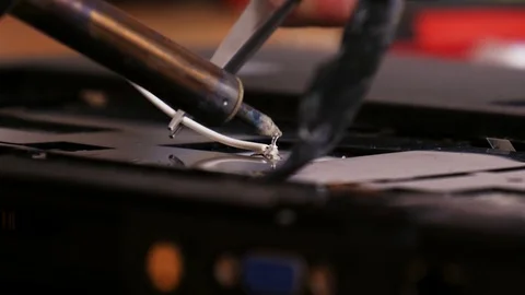 Soldering contacts on laptop computer - 4K Stock Footage 76942285