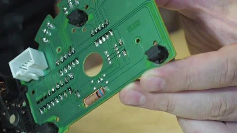 Soldering of the control unit board with a soldering iron. the board is a close Stock Footage 160921338