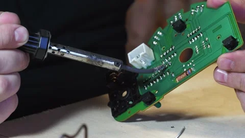 Soldering of the control unit board with a soldering iron. green board close-up Stock Footage 162411796