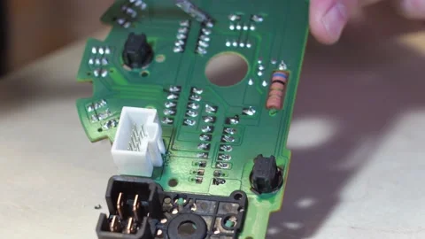 Soldering of the control unit board with a soldering iron. the board is a close Stock Footage 168899551