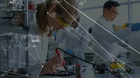Soldering engineer assembling circuit board in lab, in lab coat, holding red Stock Footage 330463234