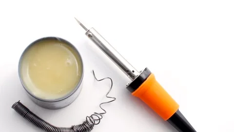Soldering iron on white surface, ready for action on creative electronics p.. Stock Footage 260823449