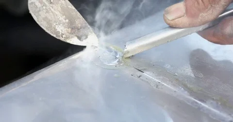 Soldering metal with a Hand tool Stock Footage 74582403