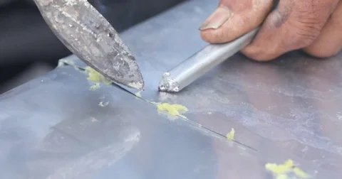 Soldering metal with a Hand tool Stock Footage 74584656