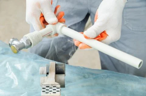 Soldering plastic pipe. Stock Photos