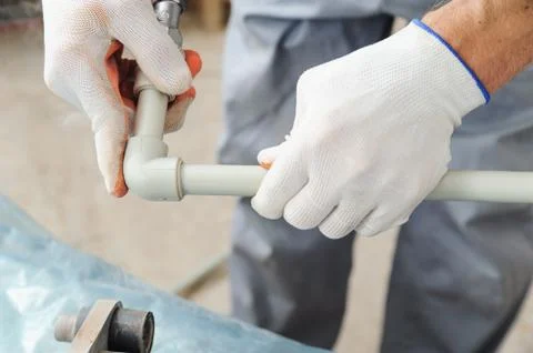 Soldering plastic pipe. Stock Photos