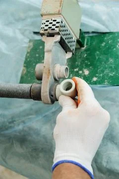 Soldering plastic pipe. Stock Photos