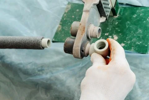 Soldering plastic pipe. Stock Photos