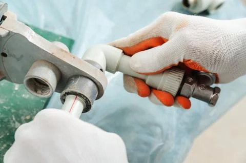 Soldering plastic pipe. Stock Photos