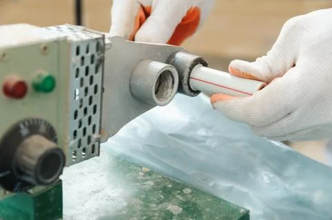 Soldering plastic pipe. Stock Photos