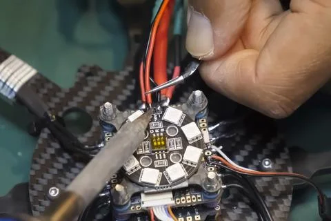 Soldering the power wires to drone controller board Stock Photos