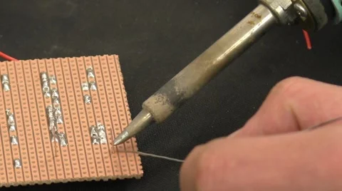 Soldering a resistor onto the circuit board Stock Footage 45976664
