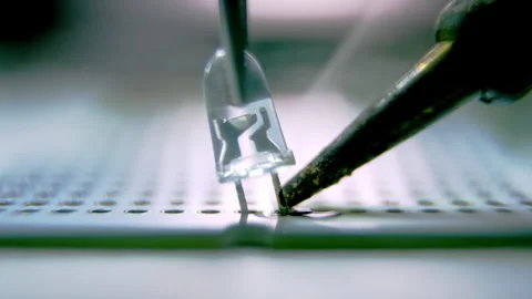 Soldering of small led bulb on device panel with pincers Stock Footage 246053253